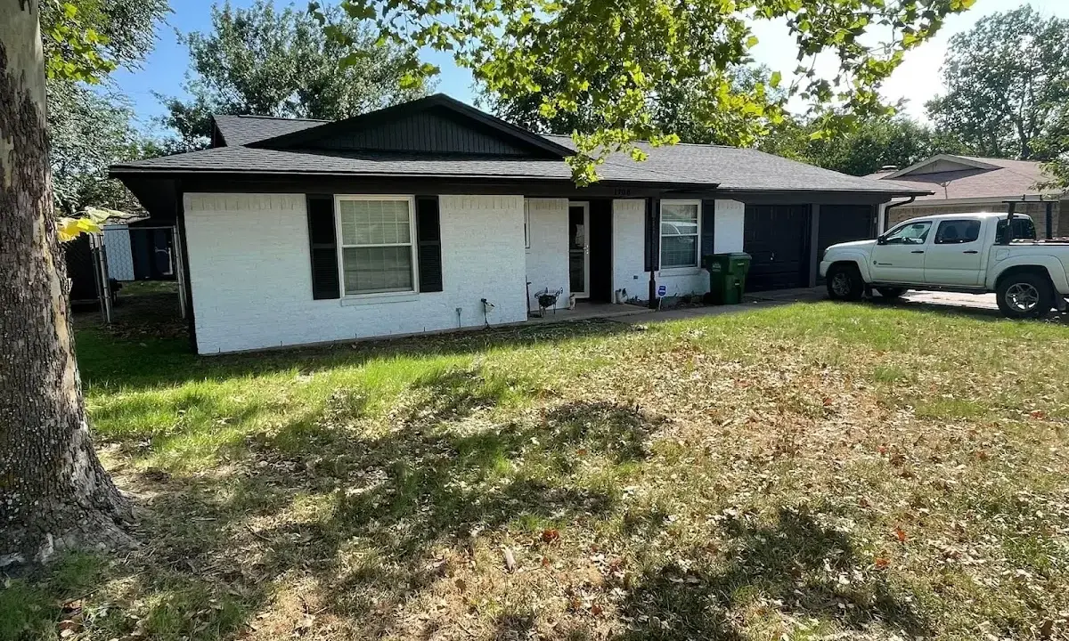 Professional roofing crew working on a residential roof in Plainview